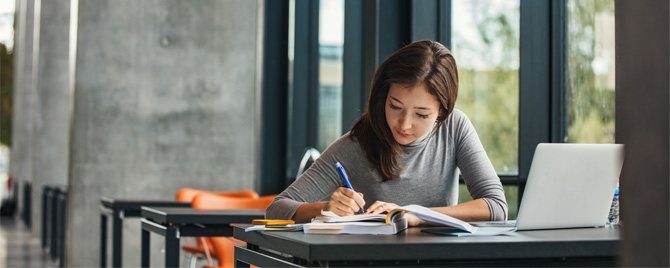 photo - a woman working on paperwork in a library